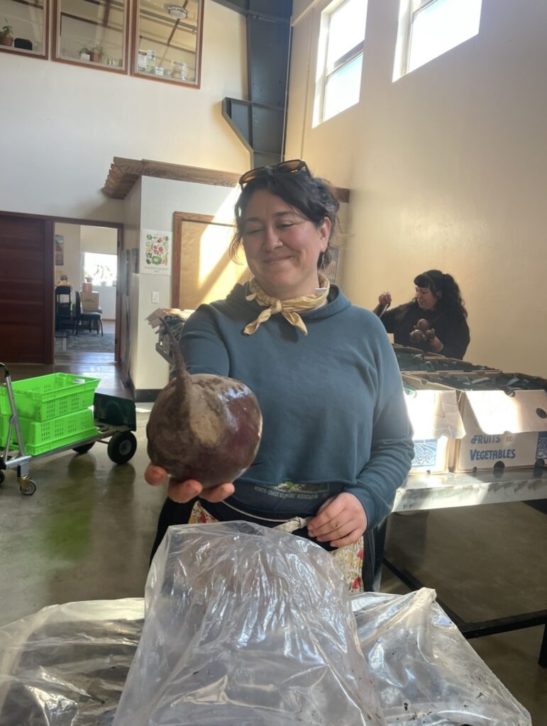 food hub coordinator holding beet